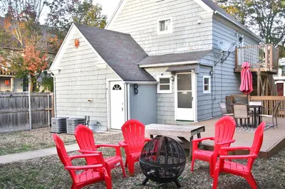 a group of red chairs and a table in front of a house at The Ultimate Lakewood Retreat! in Lakewood