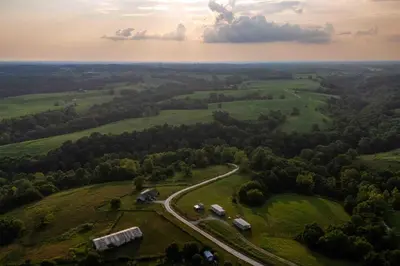 an aerial view of a green field with a road at Rustic Mt Sterling Cabin1 Near Downtown Pets OK in Mount Sterling