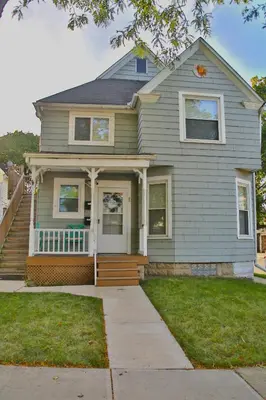 a gray house with a porch and a porch at Updated Lakewood Retreat! in Lakewood
