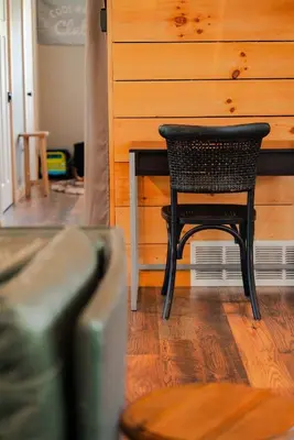 a black chair sitting at a table in a room at The Treetop Retreat – Family Getaway in Scenic Hocking Hills in Logan