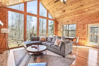 a living room with a couch and a table at Modern Luxury I Hot Tub I Hiking in McArthur