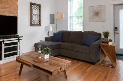a living room with a couch and a coffee table at Two Condos for 14 Guests, 5 Bedrooms, Free Parking in Covington