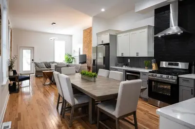 a kitchen and living room with a wooden table and chairs at 3 Bedroom Condo - Close to Stadiums & Downtown in Covington