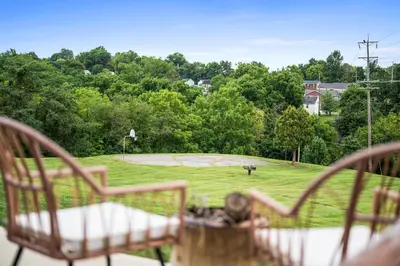 a view of a park with two chairs and a basketball court at 4BR, 2 & half Bath, Hot Tub, Private Parking, Near Ark in Dry Ridge