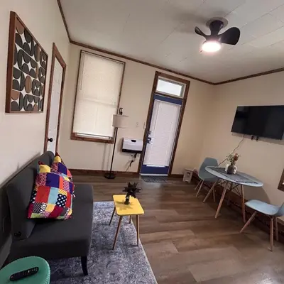 a living room with a couch and a table at Urban OASIS Inspired by the 80s Unit 1 in Cleveland