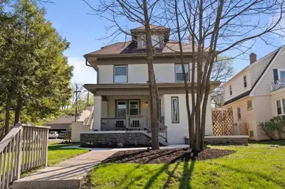 a white house with a tree in front of it at Stunning 2 BR - Parking and Walk to Park in Columbus