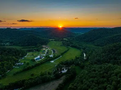 an aerial view of a valley with a sunset at Glamping Tent/Red River Access/2 Queen Beds in Stanton
