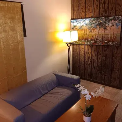 a living room with a blue couch and a table at The Unique Spot in Cleveland