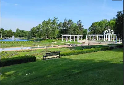 a park with a bench in a park with a fountain at Historic 2 Bdr across from Lakeside Park in Fort Wayne
