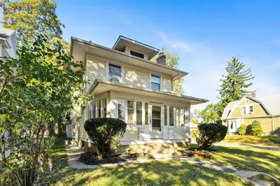 a white house with a yard at Historic 1 Bdr across from Lakeside Park in Fort Wayne
