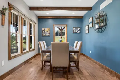 a dining room with blue walls and a table and chairs at Calaboose Retreat in Campton