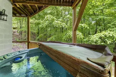 a pool of water with a boat in the middle at Hot Tub & WiFi - Birdsong - Red River Gorge KY in Stanton