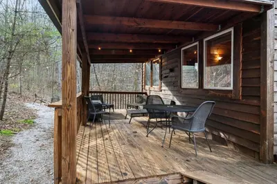 a wooden deck with chairs and a table on it at Hot Tub No Pet Fee Prime Location - Beary Cozy in Slade
