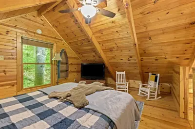 a bedroom with a bed in a log cabin at Hot Tub No Pet Fee - Beary Secluded - RRG in Slade