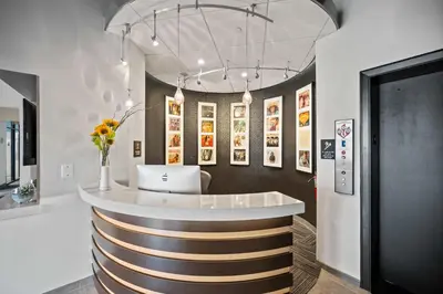 a lobby with a bar with a vase of flowers at The 333 Suites 202 - Stay for 6 in Cincinnati