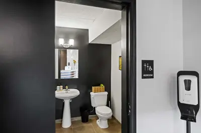 a bathroom with a white toilet and a sink at The 333 Suites 204 - Stay for 2 in Cincinnati