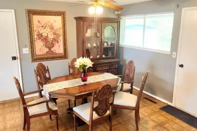 a dining room with a table and chairs at 3BR Home, Pet-Friendly, Fenced Yard Near I-70, I-75, Hospitals, Wright-Patt AFB in Dayton