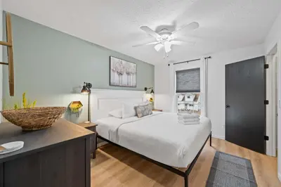a bedroom with a bed and a ceiling fan at Fire Ring Private Parking King Beds - Near Ark in Dry Ridge