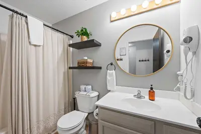 a bathroom with a sink and a toilet and a mirror at Fire Ring Private Parking King Beds - Near Ark in Dry Ridge