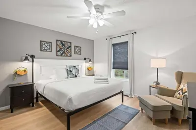 a bedroom with a bed and a ceiling fan at Fire Ring Private Parking King Beds - Near Ark in Dry Ridge