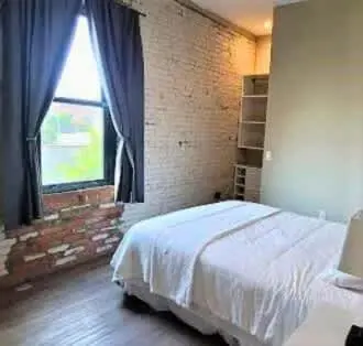 a bedroom with a bed and a large window at Jungle Vibe by Jungle House Downtown & Short North Free Parking 5 800 Reviews Near Convention Center & Nationwide Arena & Ohio State Walk to High Street in Columbus