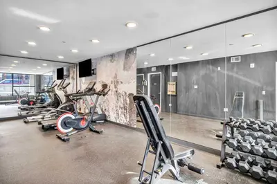 a gym with several treadmills and cardio machines at CWRU & Little Italy Stay with King Bed Gym Parking WD in Cleveland