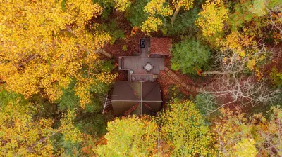 an aerial view of a house in the middle of a forest at Waterfront A- Frame with Dock, Canoe + Kayaks in Rockbridge