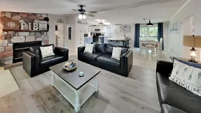 a living room with black leather furniture and a fireplace at Put-in-Bay Island Club #95 in Put-in-Bay