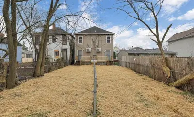 a house in a yard with a fence at Modern 2BR Yale Townhouse Near Downtown Columbus in Columbus