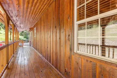 an empty porch of a wooden house with a window at Starry Mountain Night- Private Pool, Pool Table in Stanton