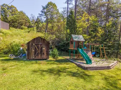 a backyard with a play set and a playground at Starry Mountain Night- Private Pool, Pool Table in Stanton