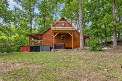a cabin in the woods with a tree at Furnace Mountain Retreat- Hot Tub, Fireplace, WiFi in Stanton