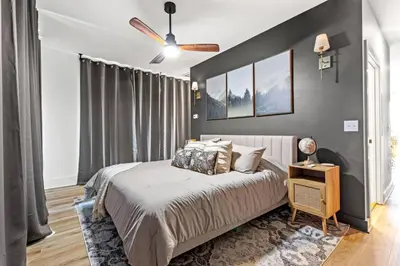 a bedroom with a bed and a ceiling fan at Primrose- Hot Tub, Firepit, Wraparound Deck, WiFi in Wellington