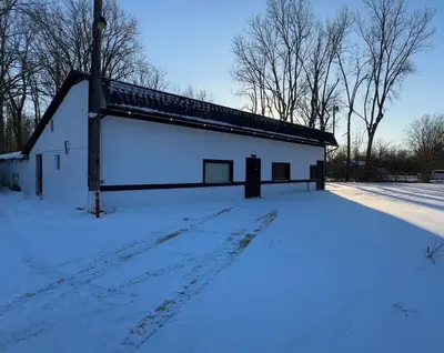 a large white building with snow on the ground at Slice of Petersburg