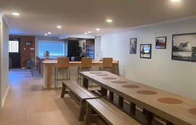 a living room with a table and a counter with benches at Slice of Petersburg