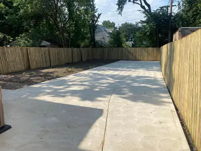 a sidewalk in front of a wooden fence at 1469 east 116th in Cleveland