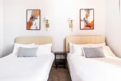 two beds sitting next to each other in a bedroom at CLE Large Loft/Wolstein/Progressive/Playhouse/CSU in Cleveland