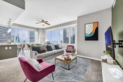 a living room with a couch and a table at 14th Floor Lux Downtown Condo w/ LAKE VIEWS & Gym in Cleveland