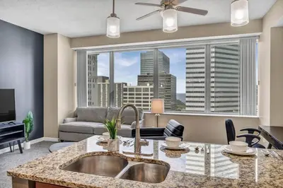 a kitchen with a sink and a large window at Luxury High-Rise • 18th Floor Condo • Parking $ in Cleveland