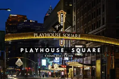 a play house square sign on a building in a city at HUGE Panoramic SkySuite w/ Downtown VIEWS: Gym in Cleveland