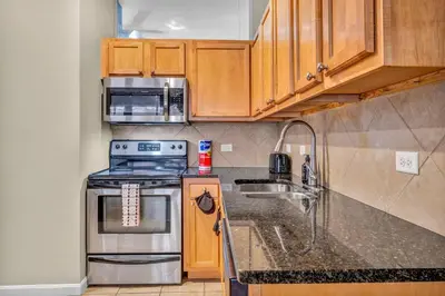 a kitchen with a stove and a microwave at Play & Stay Loft Central, Comfy, Parking in Cleveland