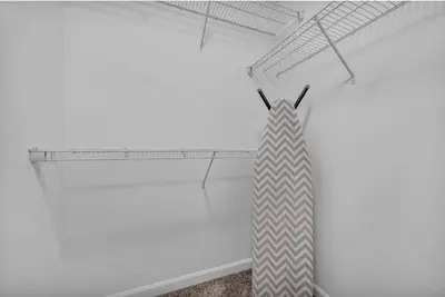 a white room with a tie on a shelf at Playhouse Square Suite | Downtown | Parking in Cleveland