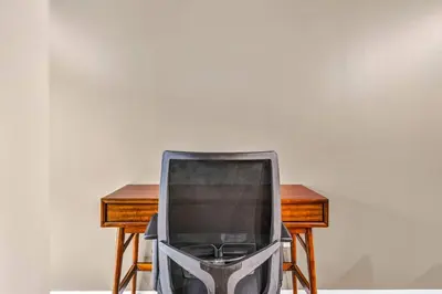 a tv sitting on a chair next to a desk at Luxe Downtown Condo • Pool Table & Parking in Cleveland