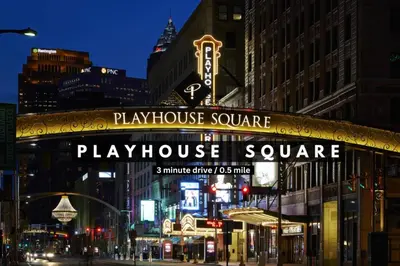 a playhouse square sign on a city street at night at Warm and Cozy Downtown Flat: Paid Parking in Cleveland