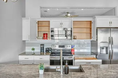 a kitchen with white cabinets and stainless steel appliances at The Halle Downtown 1BD | Parking/Gym/Security in Cleveland