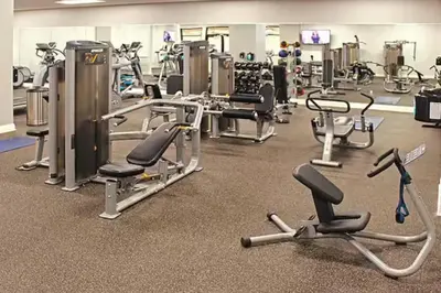a gym with lots of cardio equipment and exercise bikes at Gorgeous Downtown Flat| Parking•Gym•Security in Cleveland