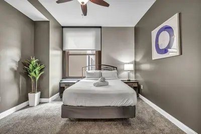 a bedroom with a bed and a ceiling fan at Historic Loft in the Heart of Downtown • Gym in Cleveland