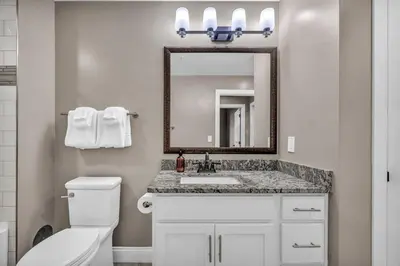 a bathroom with a toilet and a sink and a mirror at Historic Loft in the Heart of Downtown • Gym in Cleveland