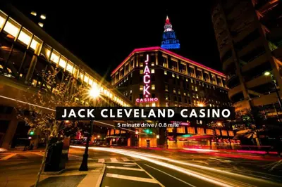 a street sign in front of a building at night at Amazing Downtown Apartment in Incredible Location! in Cleveland