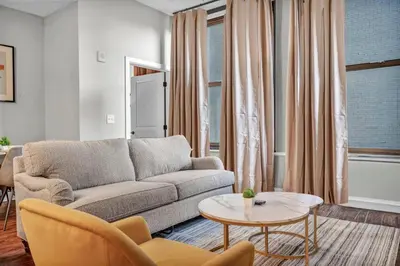 a living room with a couch and a table at Perfect Luxury Flat • Heart of Downtown • Gym in Cleveland